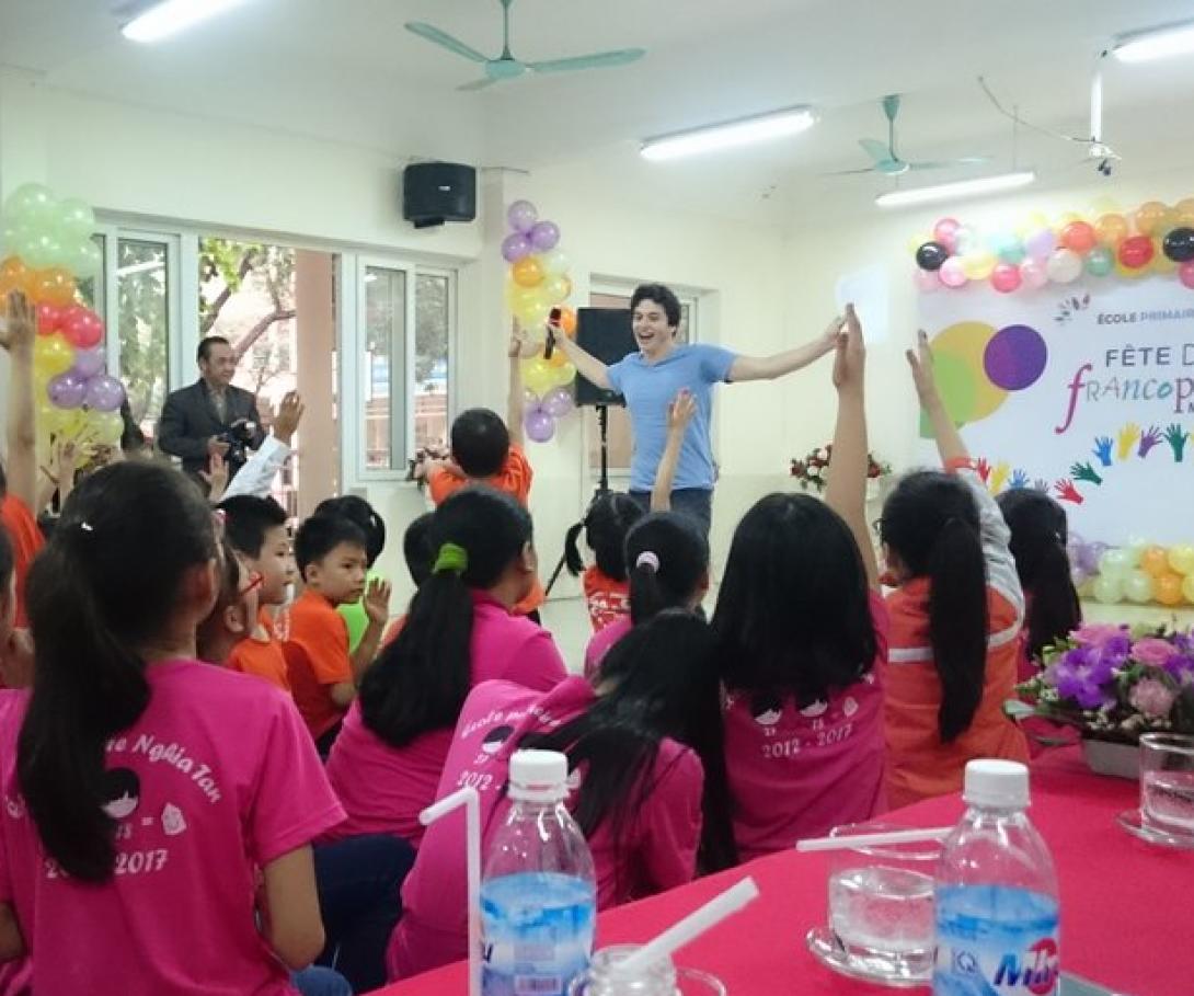 A participant from the Westpoint University volunteer group speaks to Vietnamese students in Asia. A student from Westpoint University gives a presentation to children in Vietnam during his group volunteer trip.